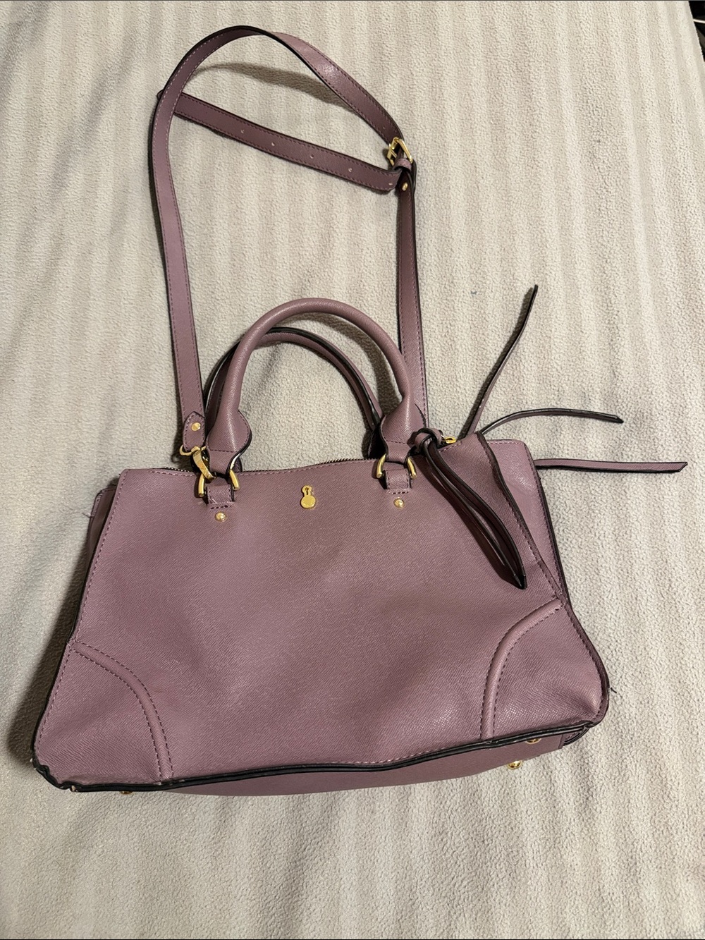 London Fog purple purse. Multi straps and three zippered compartments.